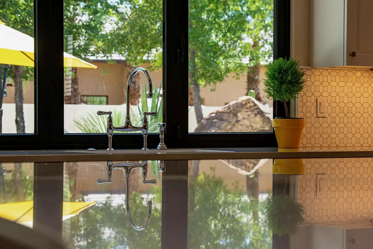 Kitchen window over the sink in a black frame